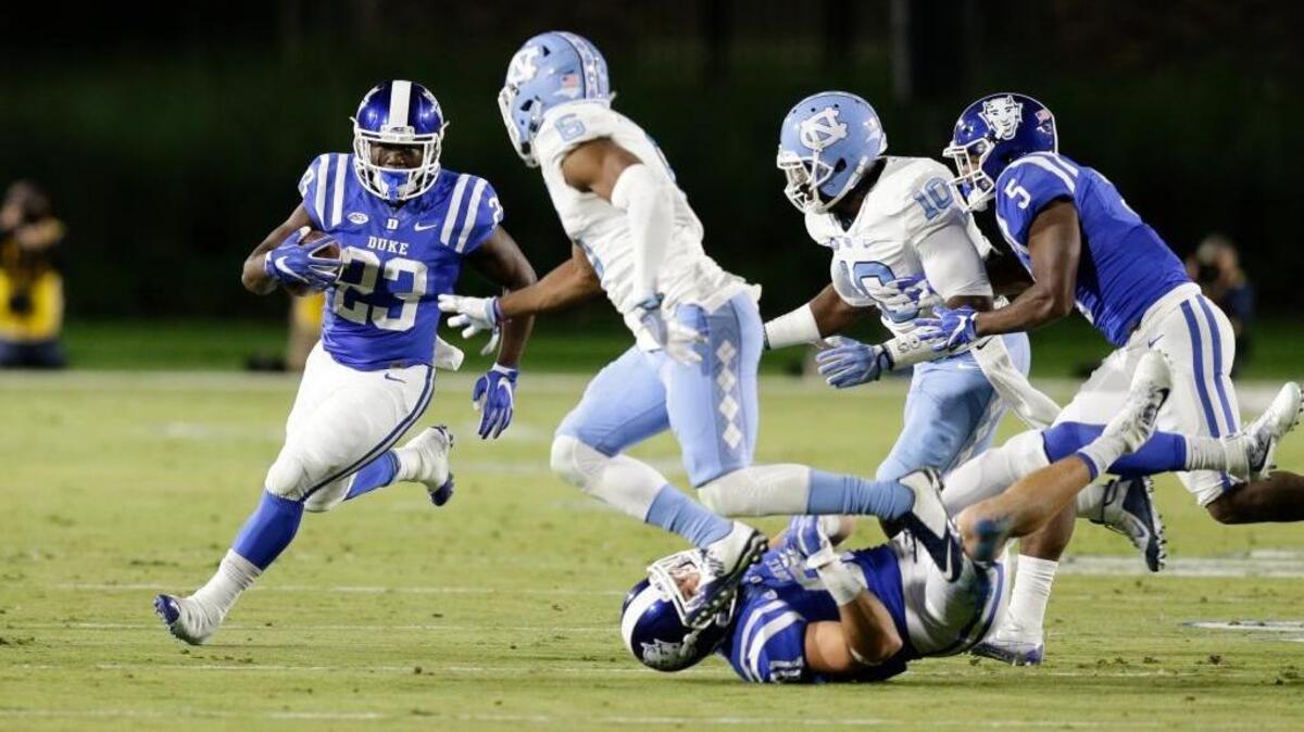 Joseph Ajeigbe, left, runs the ball against North Carolina last season. The Duke transfer brings Sacramento State some experience at running back.