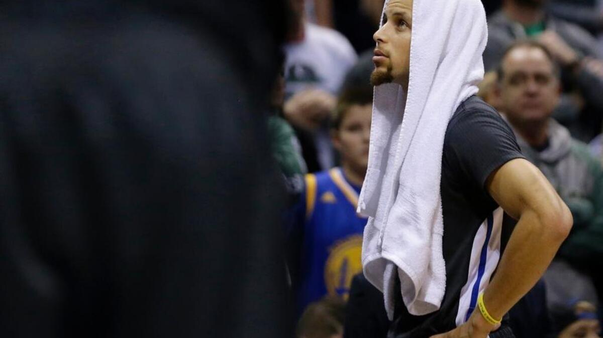 The Golden State Warriors’ Stephen Curry looks on during an NBA basketball game against the Milwaukee Bucks, Saturday, Dec. 12, 2015, in Milwaukee. The Warriors lost, ending their season-starting winning streak at 24. They bring a 72-9 record into Wednesday’s final regular-season game against the visiting Memphis Grizzlies.