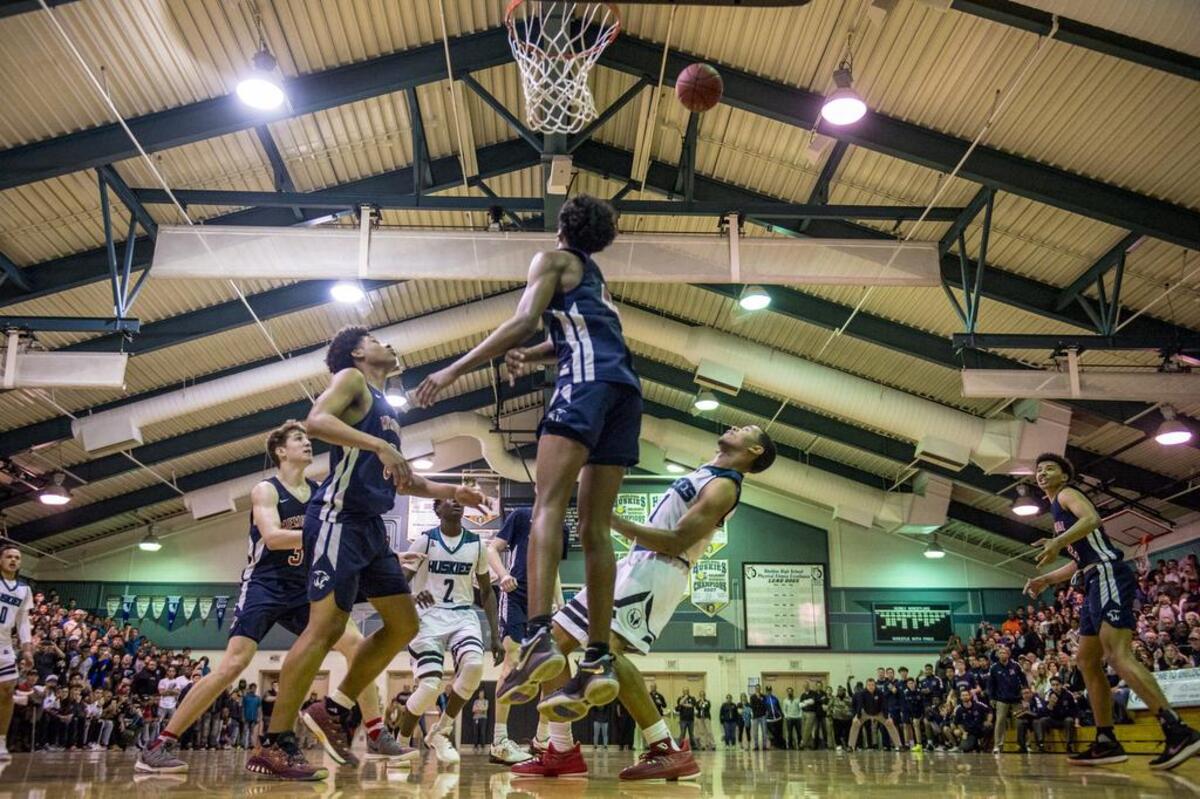 Sheldon Huskies guard Dom Johnson (1) watches his shot float over San Joaquin Memorial Panthers guard Jalen Green (C) (4) into the basket to give the Huskies a two point lead with four seconds left in overtime.
