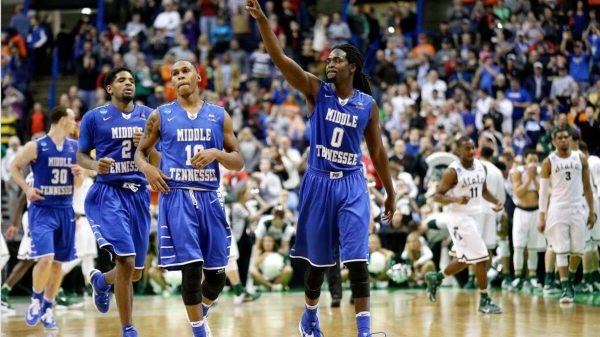 Middle Tennessee’s Darnell Harris (0), Jaqawn Raymond (10 ) and Perrin Buford (2) celebrate as they walk off the court after their huge 90-81 upset of Michigan State in the first round of the NCAA Tournament on Friday, March 18, 2016, in St. Louis.