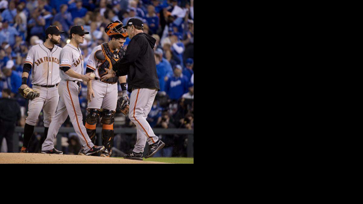 
San Francisco Giants starting pitcher Jake Peavy (22) hands the game ball to manager Bruce Bochy after getting pulled in the second inning in Game 6 of the World Series at Kauffman Stadium in Kansas City, Mo, on Tuesday.
