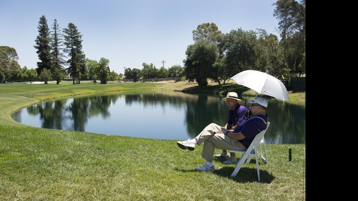 
Volunteers Gary Constable of Livermore, left, and Scott Moeszinger of Placerville relax at the 12th hole at Del Paso Country Club as they wait for golfers to to pass through during practice rounds of the 2015 U.S. Senior Open. If you aren’t at the event – or even if you are – options exist for following the action.
