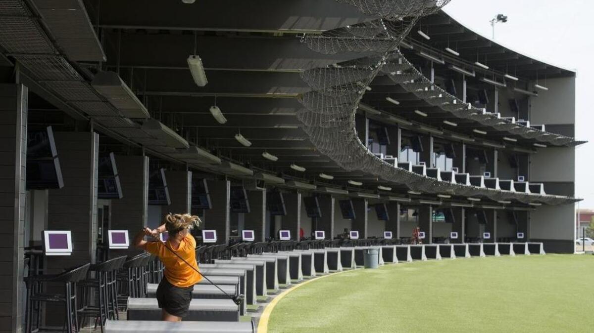 A golfer hits a ball at TopGolf in Roseville in 2016.