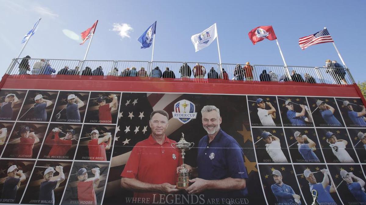 Fans watch from a grandstand on the second hole during a practice round for the Ryder Cup golf tournament Tuesday, Sept. 27, 2016, at Hazeltine National Golf Club in Chaska, Minn.