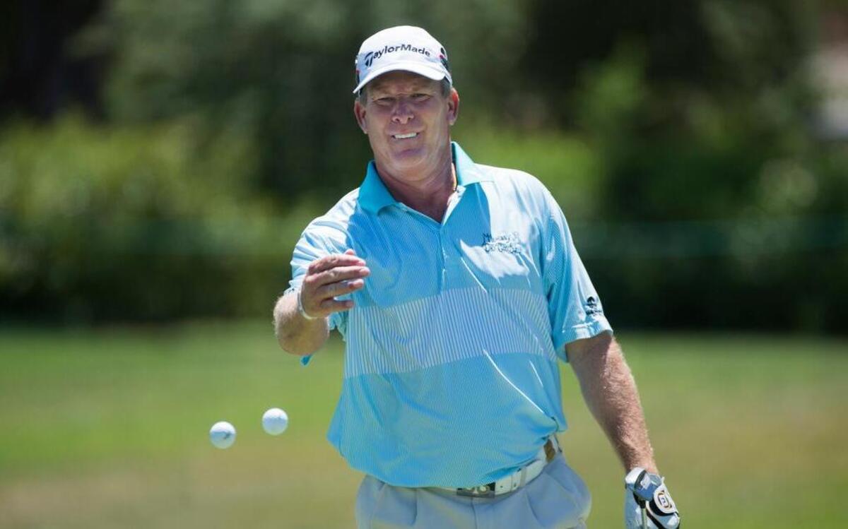 
Woody Austin, throwing balls on the 14th green during a U.S. Senior Open practice round, said young players no longer have to prove themselves because of technology.
