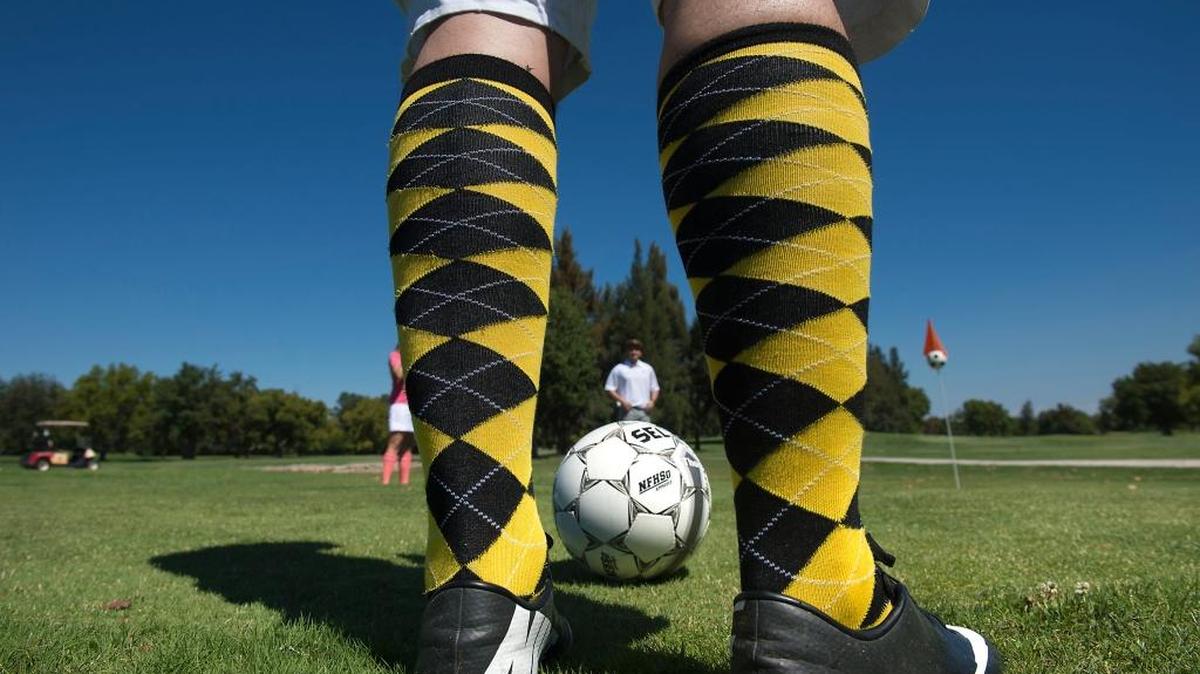 Wearing golfer's traditional argyle socks, Foot golfer Salami Cancilla of Roseville prepares to begin a round of Foot Golf at Haggin Oaks Golf Complex in Sacramento in September 2013. Foot Golf is played with a soccer ball on a course laid out like a golf course. Players kick the ball down the fairway and ultimately into a cup large enough to accommodate the larger ball.