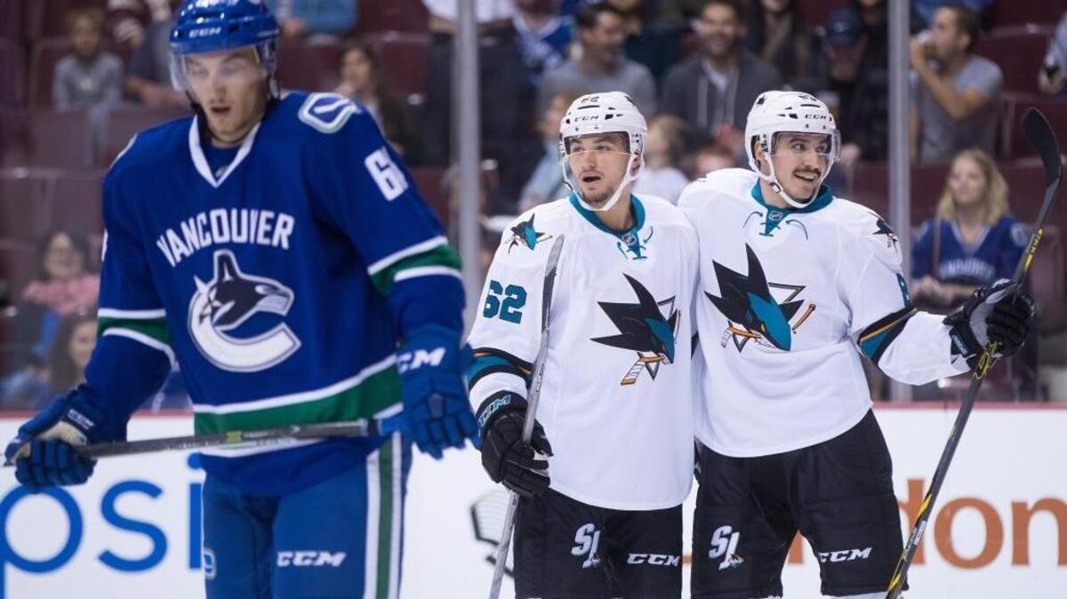 The San Jose Sharks’ Kevin Labanc, center, and Matt Nieto celebrate Nieto’s goal as the Vancouver Canucks’ Borna Rendulic skates away during the first period of a preseason NHL hockey game Sunday, Oct. 2, 2016, in Vancouver, British Columbia. The Sharks won 3-2 in overtime when Nieto scored a second goal.