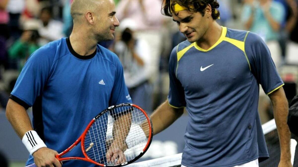 Andre Agassi, left, and Roger Federer of Switzerland, meet at the net following the men’s final at the U.S. Open tennis tournament in New York on Sunday, Sept. 11, 2005. Federer won 6-3, 2-6, 7-6 (1), 6-1.