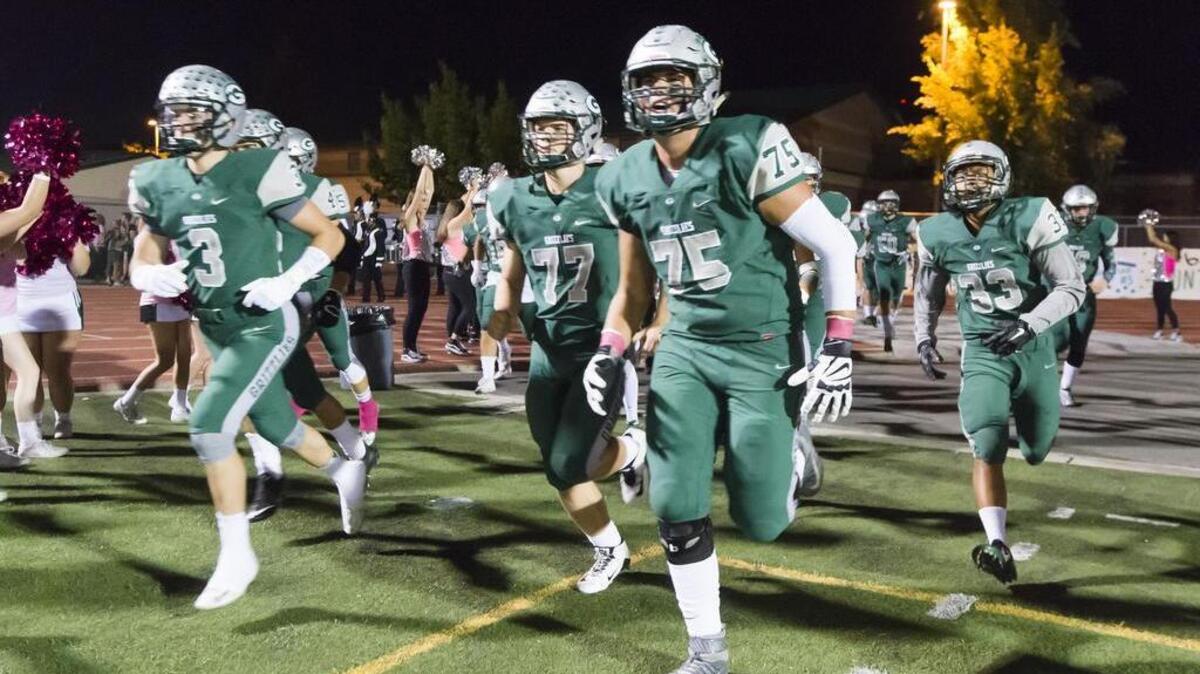 
The Granite Bay Grizzlies come onto the field before the game as the Granite Bay Grizzlies host the Oak Ridge Trojans, Friday, October 9, 2015.
