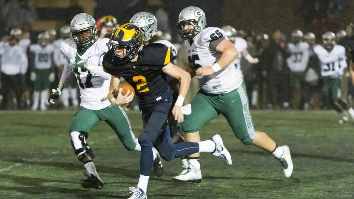 Oak Ridge Trojans Marco Baldacchino (2), runs for a touchdown to lead 7-0 after the point after attempt was good during the first quarter as the Oak Ridge High School Trojans host the Granite Bay Grizzlies, Friday, Oct. 14, 2016.