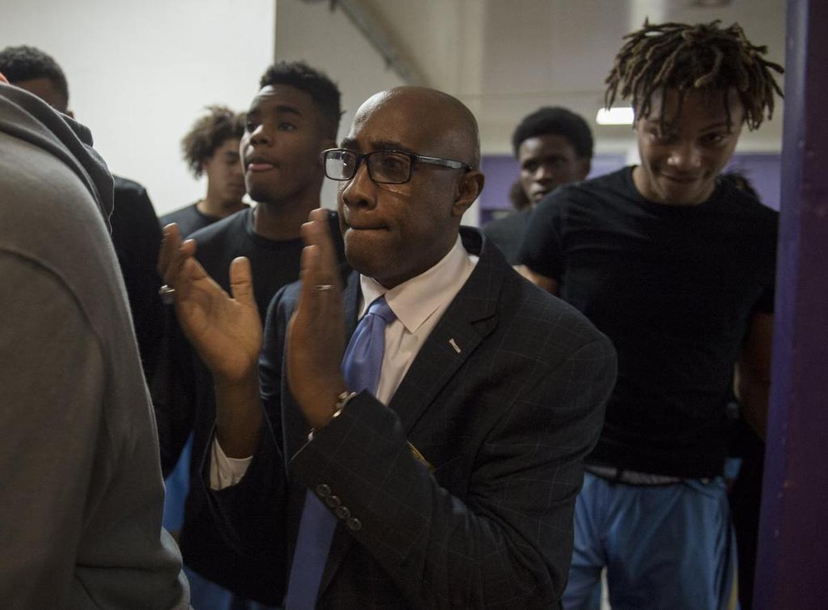 Burbank Titans head coach Lindsey Ferrell leads his team onto the floor before No. 14 Sacramento knocked off No. 3 Burbank 61-56 at Sacramento High School on Friday, Feb. 10, 2017.