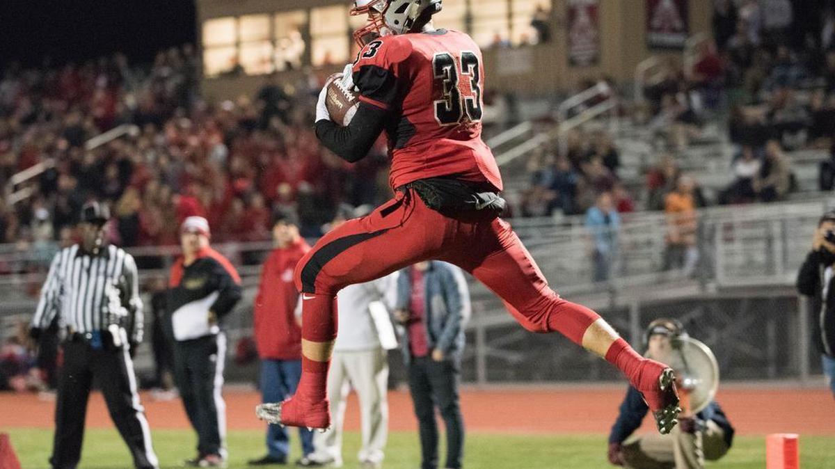 Antelope Titans' Ryan McCombs (33) catches a pass for a touchdown in the second quarter, as the Titans host the Sacramento Dragons on Friday, November 20, 2015.