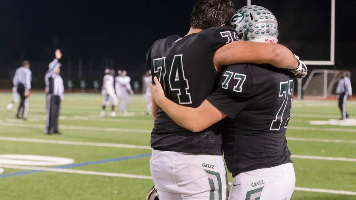 Granite Bay Grizzlies’ Will Craig (74) hugs Joseph Young (77) on the sidelines near the end of the game as the Granite Bay Grizzlies varsity football team fall 37-14 to the Pittsburg Pirates football team in the CIF NorCal Division I-A title game, Saturday, Dec. 9, 2017.