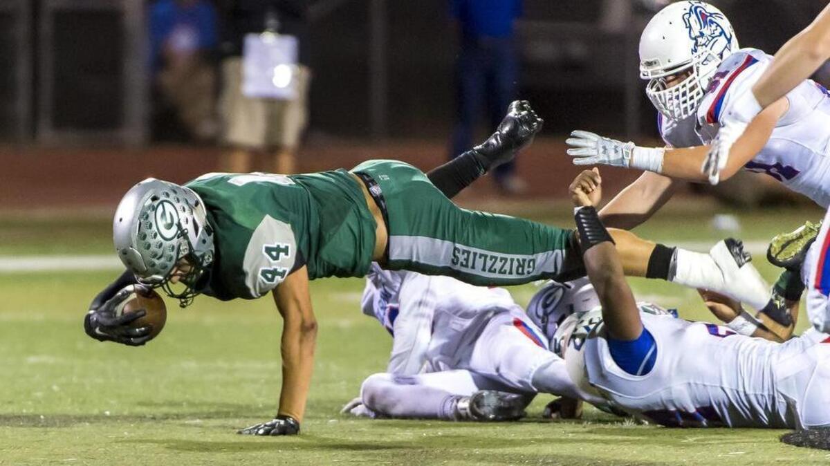 
Granite Bay Grizzlies Alex Martinez (44), dives for more yardage during the fourth quarter as the Granite Bay Grizzlies host the Folsom Bulldogs, Friday September 25, 2015.
