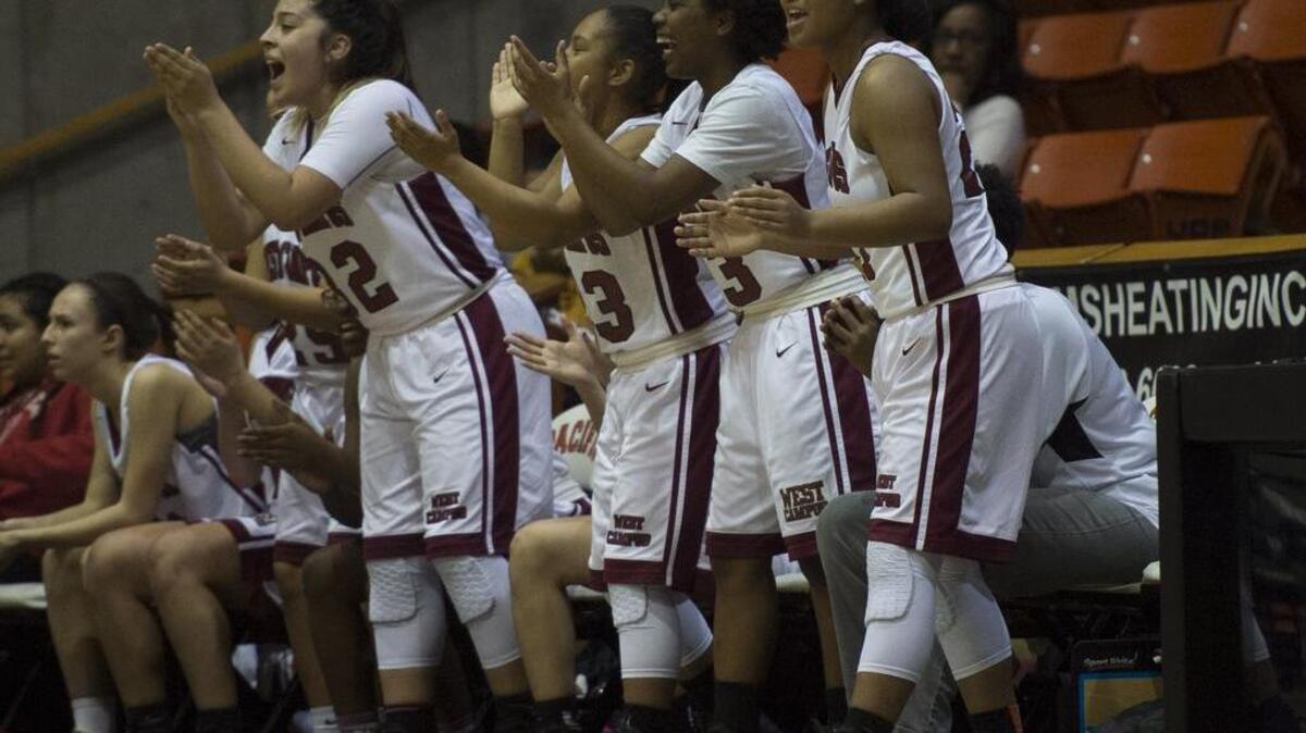 The West Campus Warriors react after a teammate makes a three-point shot at the Sac-Joaquin Section Division IV championship game between the No. 1 seed West Campus Warriors and the No. 3 seed Foothill Mustangs on March 3 at the Alex G. Spanos Center in Stockton, Calif.