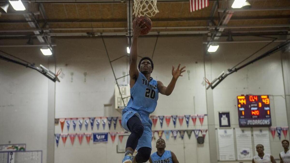 Burbank Titans Isiah Davis (20) lays a ball up for two points to give the Titans a 45-44 lead after three quarters, as No. 14 Sacramento knocks off No. 3 Burbank 61-56 at Sacramento High School on Friday, February 10, 2017.