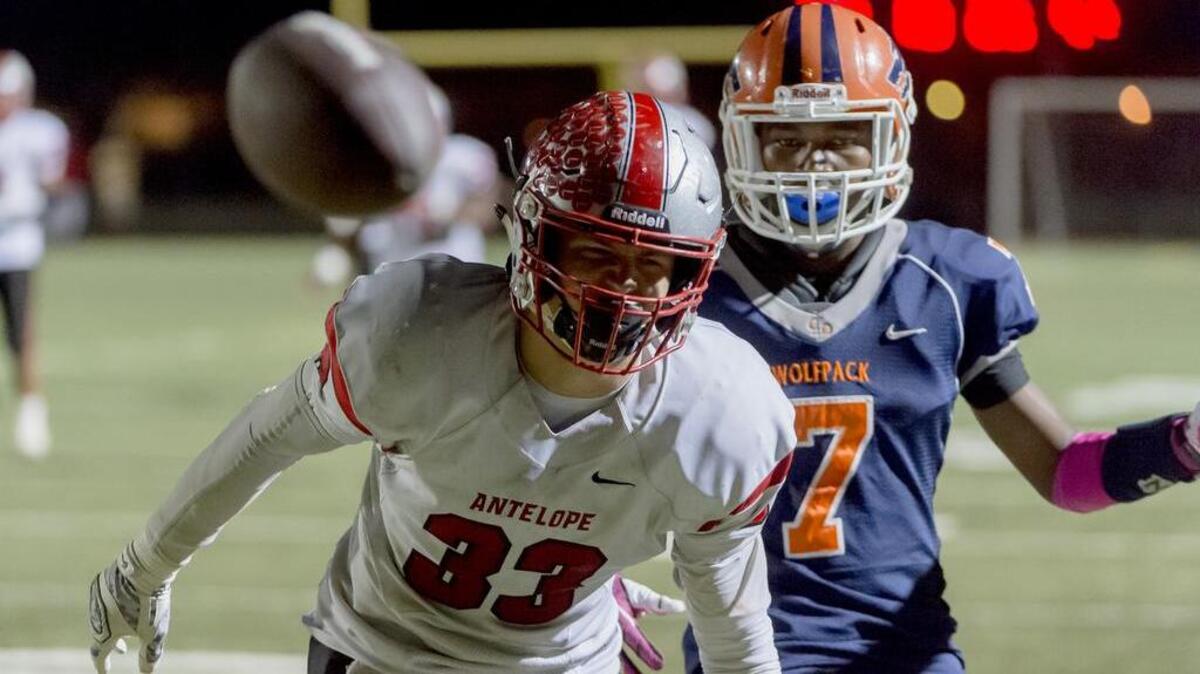 
Antelope Titan's Ryan McCombs (33), just miss a pass intended for him as Cosumnes Oaks Wolfpack's Christian Mcfarland (7), defends during the fourth quarter as the Cosumnes Oaks Wolfpack host the Antelope Titans, Friday, October 16, 2015. 

