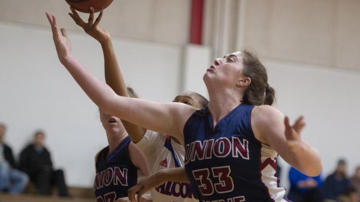 Union Mine center Carley Zaragoza (33) and Christian Brothers guard Bria Shine (41) battle for a rebound in the first half of a CIF NorCal Regional Division III playoff Tuesday night at Christian Brothers in Sacramento. Union Mine, seeded 16th, upset top-seeded Christian Brothers 54-47.