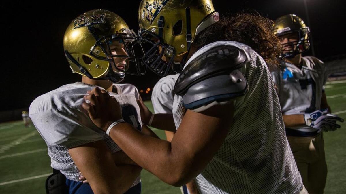
Elk Grove’s Ryan Robards jokes with teammate Lau Ta’amu during practice at Elk Grove High School Tuesday. The versatile Robards rushed for 186 yards and three touchdowns and returned an interception 20 yards for a score in Elk Grove’s 48-14 win over Yuba City on Friday night.
