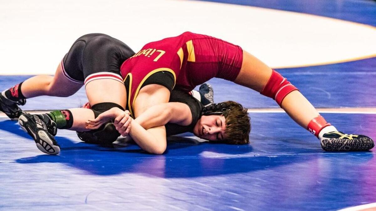 Bella Vista High School’s Alex Hedrick (black) performs an arm-bar on Mary Lopez of Liberty High School (red) during the CIF State Girls State Wrestling Championship in Visalia on Feb. 24, 2017.