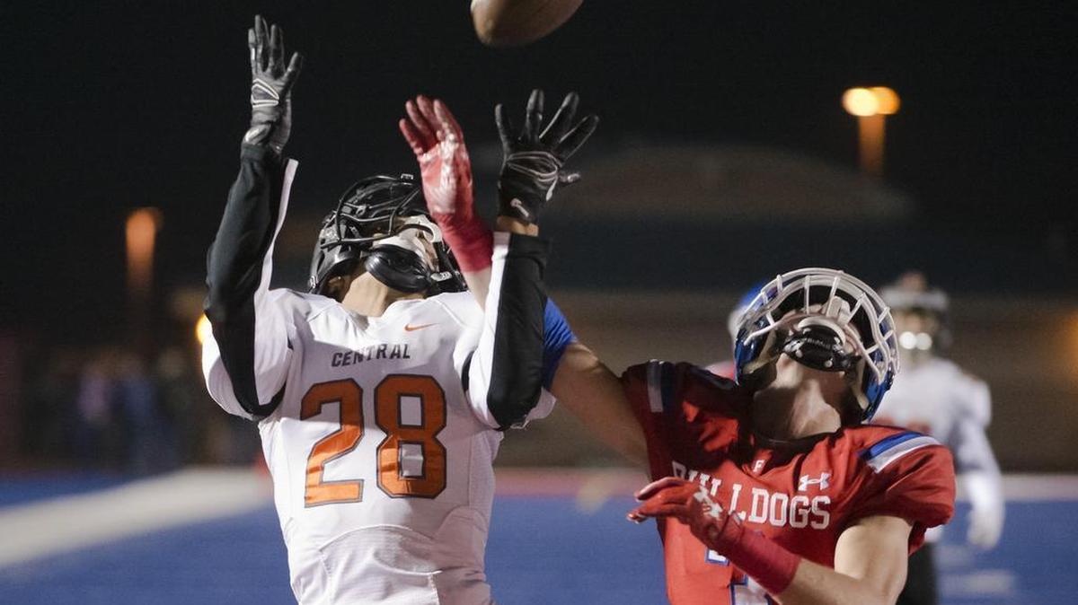 Folsom Bulldogs CJ Hutton (3) defends a pass intended for Central High School Grizzlies David Brown (28) during the first quarter.