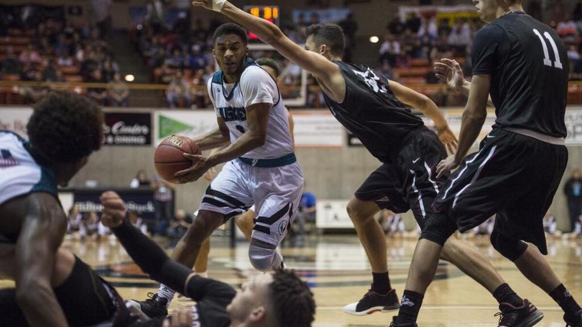 Sheldon Huskies guard Elishja Duplechan (1) drives towards the basket under heavy pressure during the third quarter at the Division I Sac-Joaquin Section basketball championship game between the Sheldon Huskies and the Woodcreek Timberwolves on Saturday, March 4, 2017, at the Alex G. Spanos Center in Stockton.