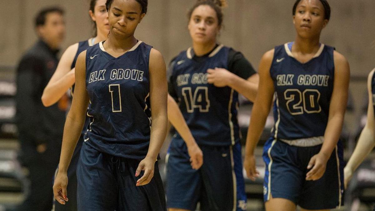 Elk Grove’s Ikeysha Smith (1), Paiton Demps (14) and Keyara McCoy walk off the court after losing to Vanden.