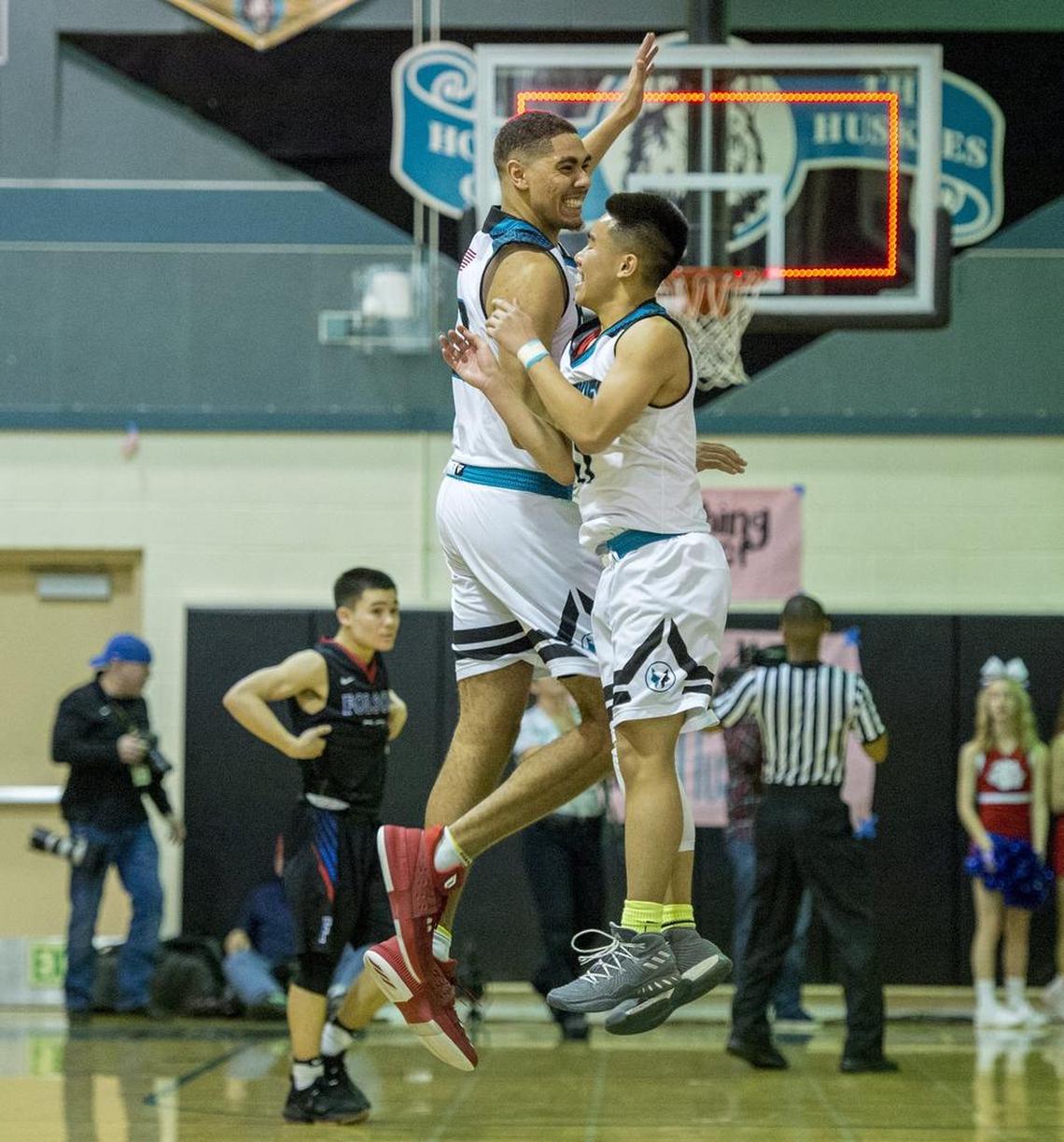 Sheldon Huskies center Chris Wriedt (23) and teammate guard Justin Nguyen (11) bump at center court after the Huskies 69-65 victory in the D1 boys semifinal between Folsom and Sheldon on Wednesday, Feb. 28, 2018 in Elk Grove.