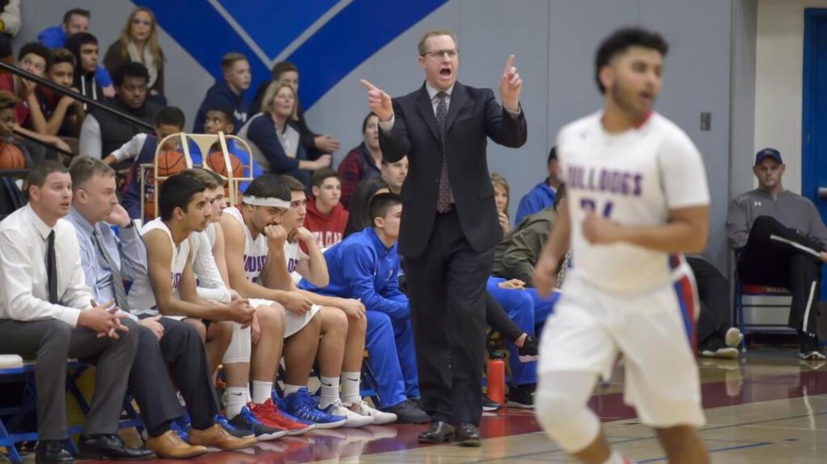 Folsom High School Bulldogs head coach Mike Wall yells at his team as the Folsom Bulldogs host the Woodcreek Timberwolves, Friday, Jan. 20, 2017.
