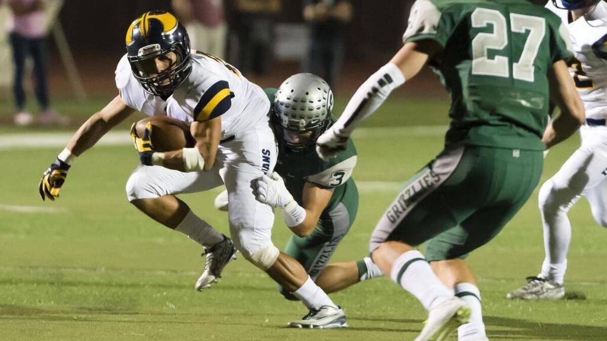 
Granite Bay Grizzlies Hunter Loomis (3), tackles Oak Ridge Trojan Alex Voege (25), aftr his catch during the first quarter as the Granite Bay Grizzlies host the Oak Ridge Trojans, Friday, October 9, 2015. 
