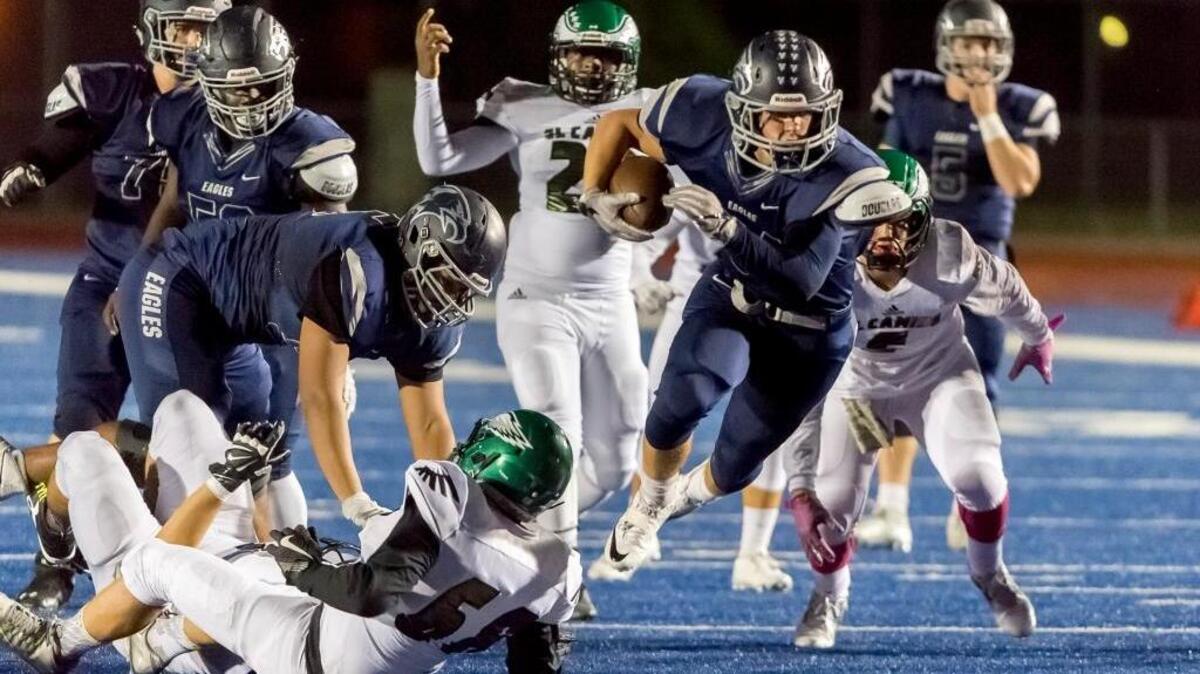 Vista del Lago’s Dominick Norris (34) rushes against El Camino during last season when they played their home games at Folsom High School. Norris and the Eagles officially dedicated their new home field Friday night but lost to Placer.