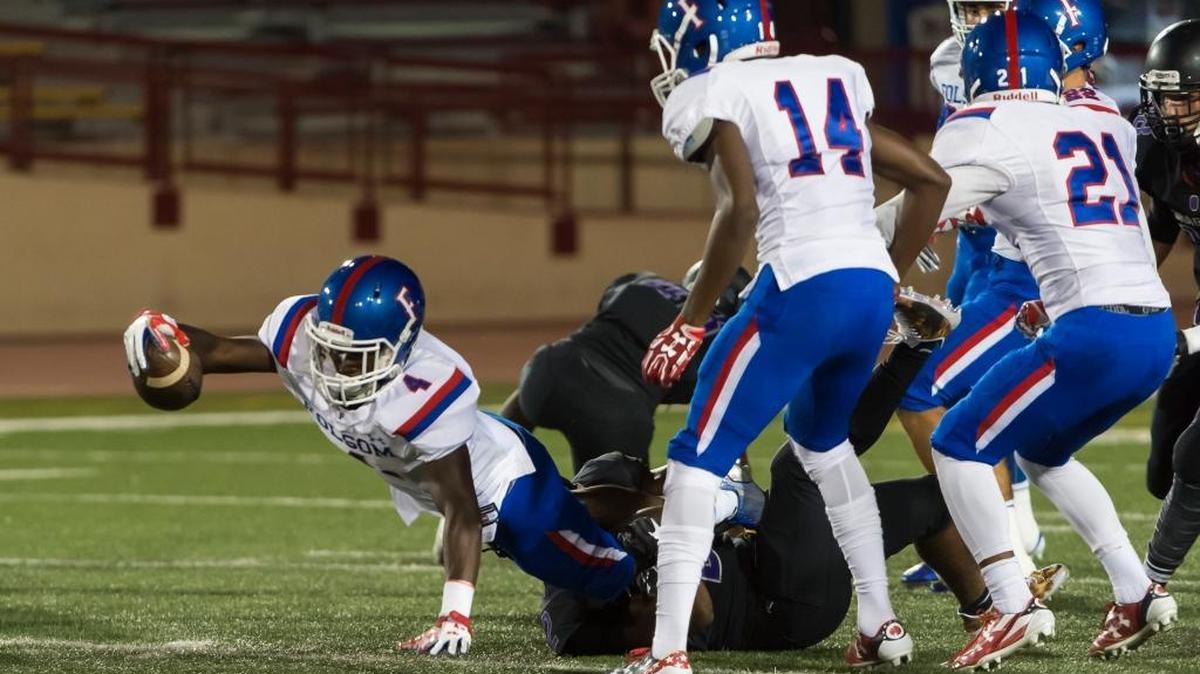 FILE - Folsom Bulldogs Daniyel Ngata (4), dives for yardage during the first quarter as the Sacramento Dragons host the Folsom Bulldogs varsity football team at Hughes Stadium at Sacramento City College, Sept. 15, 2017. Ngata and his brother, Joe, combined for five touchdowns Friday, Oct. 27, 2017, at home against Rocklin.