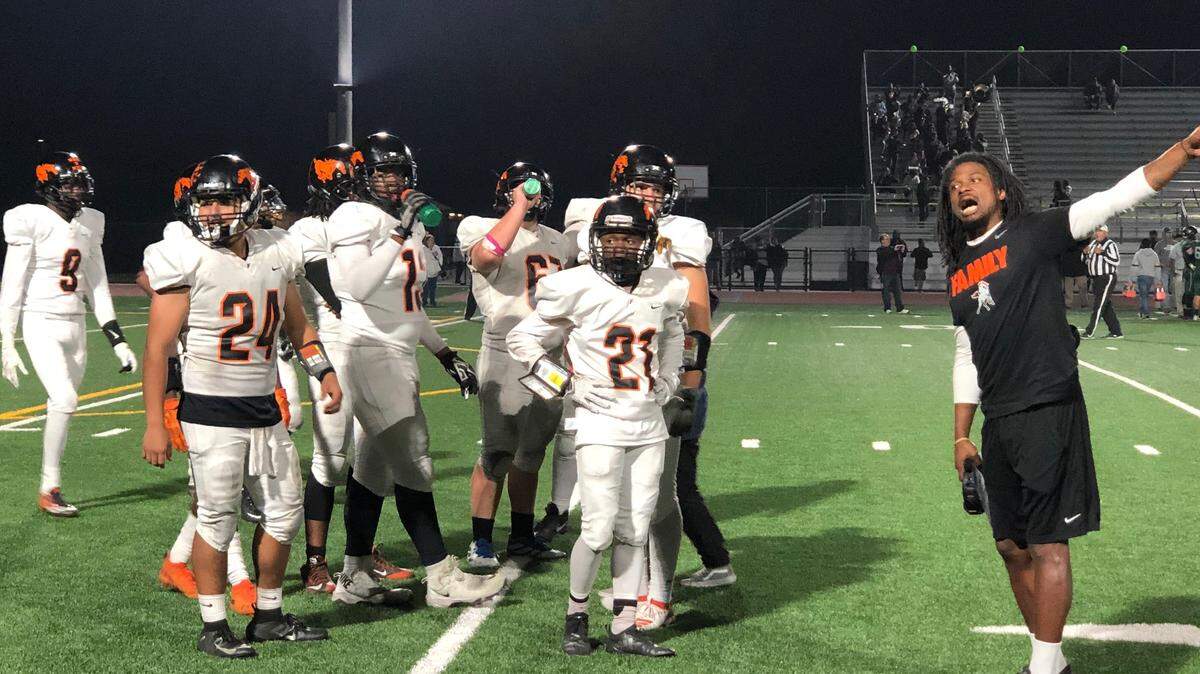 Foothill coach Mervin Brookins discusses a call with an official during his team’s 47-30 Division V playoff win Friday night.