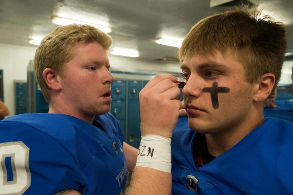 Rocklin’s Chase Webb paints the face of Blayden Brown before last season’s Quarry Bowl against Whitney. On Friday against Whitney, Brown intercepted three passes, returning one for a touchdown, and also ran for a score.