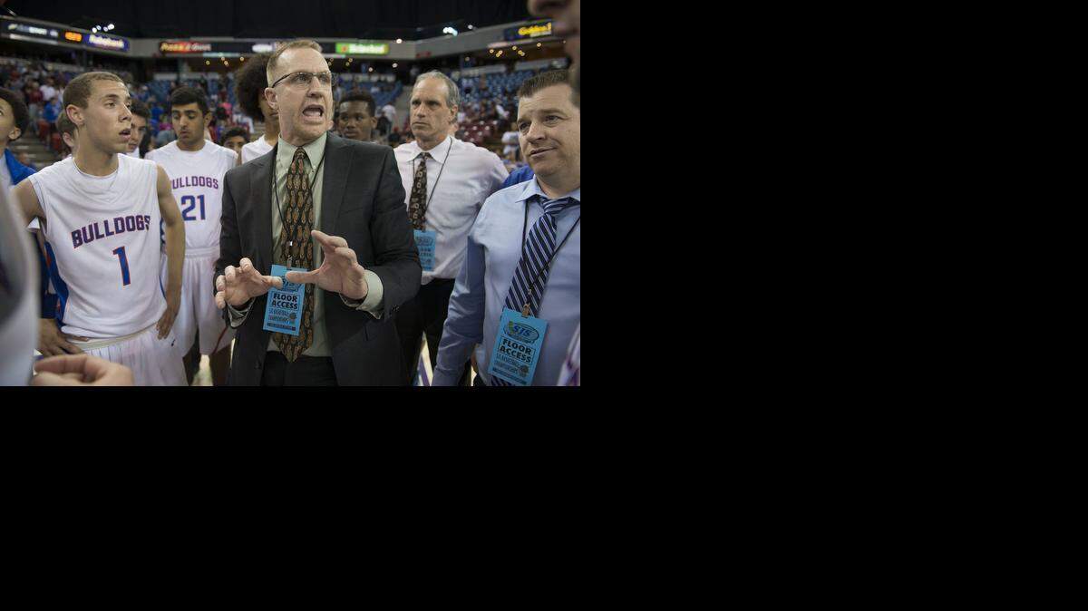 
Folsom head coach Mike Wall gives his players late-minute instructions during a timeout late in their game against Sheldon during the San Joaquin Section Division I Championship at Sleep Train Arena on Saturday, March 7, 2015, in Sacramento.
