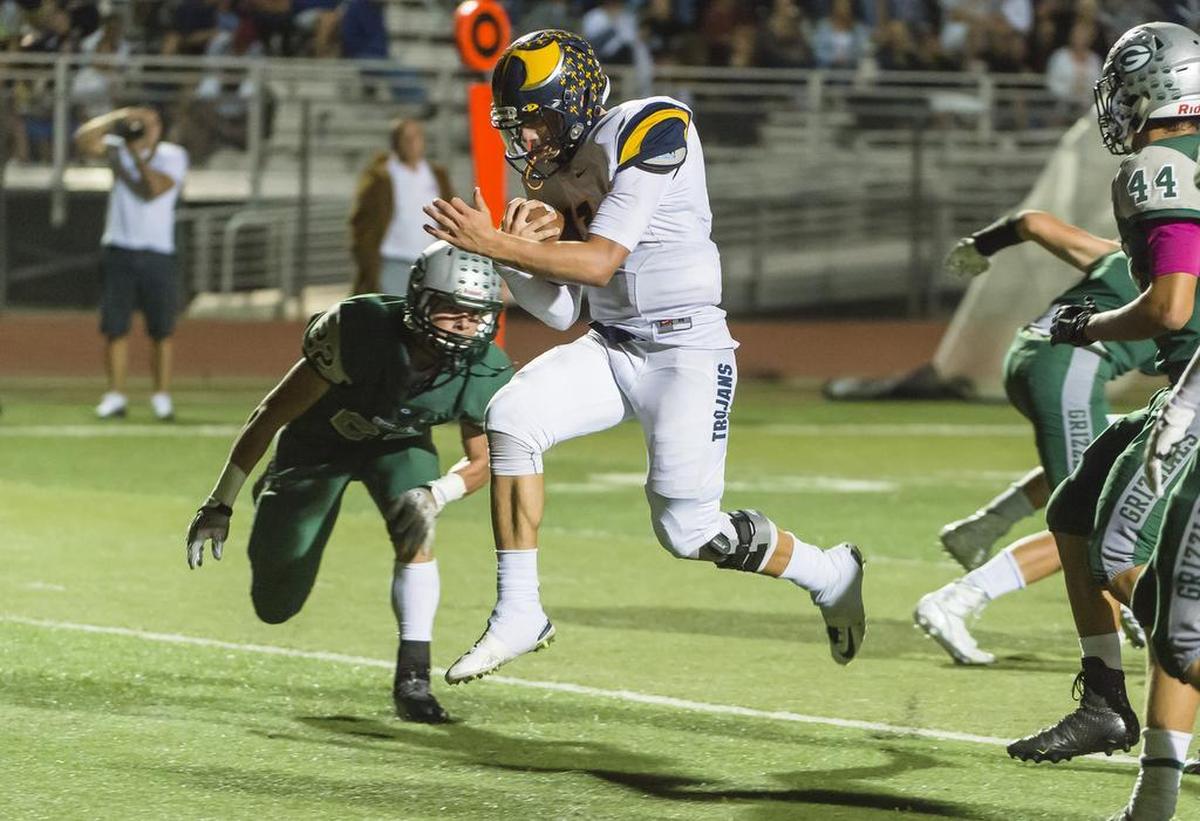 Oak Ridge Trojans quarterback Ian Book runs for a touchdown against the Granite Bay Grizzlies on Friday, Oct. 9, 2015, at Granite Bay High School.