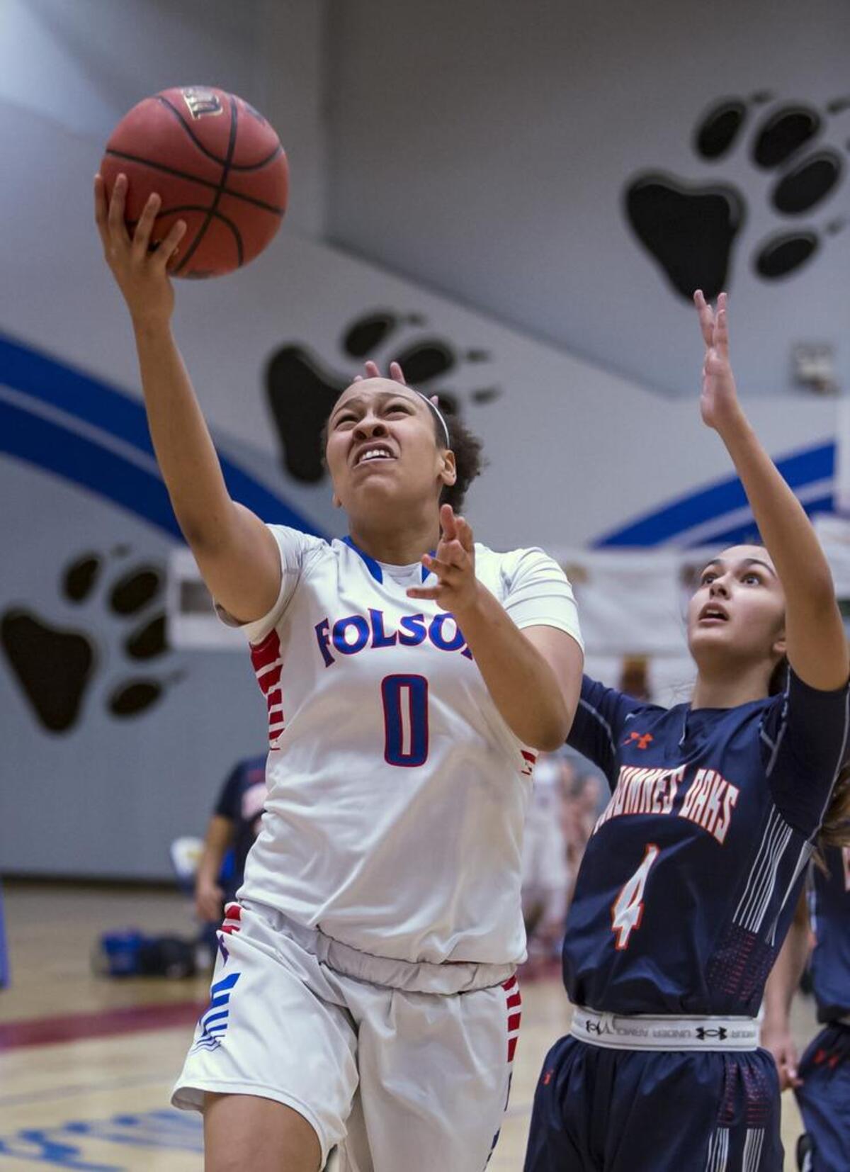 Folsom Bulldogs McKenzie Forbes (0) shoots the ball over Cosumnes Oaks Wolfpack's Jasmine Hess (4) during the first quarter.