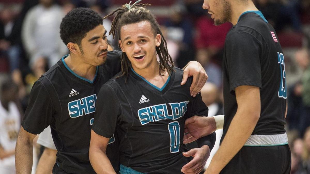 Sheldon guard Kaito Williams (12) and guard Dale Currie (0) celebrate their team's 61-60 victory against Bishop O'Dowd.