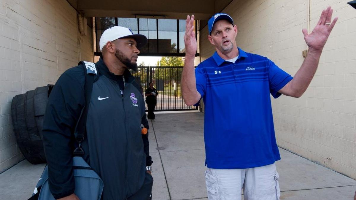 Sacramento High coach Joe McCray, left, greets Folsom coach Kris Richardson before their teams play Friday at Hughes Stadium.