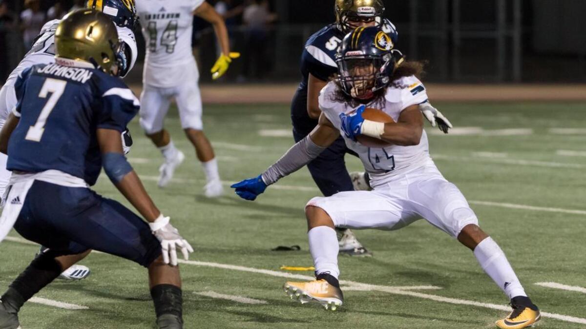 Inderkum Tigers Destynd Lewis (4), runs with the ball during the third quarter as the Elk Grove Thundering Herd varsity football team host the Inderkum Tigers, Friday Aug 25, 2017.