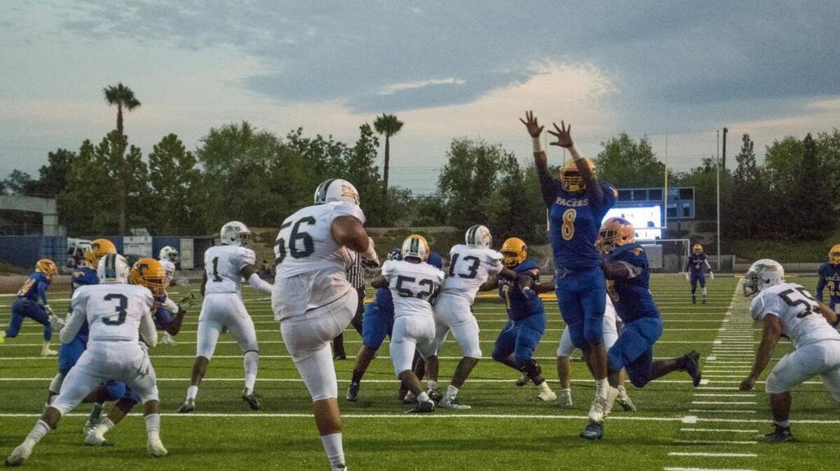
Grant Pacers David Moala (8), just misses to block the punt by Burbank’s Aleki Tapa (56).
