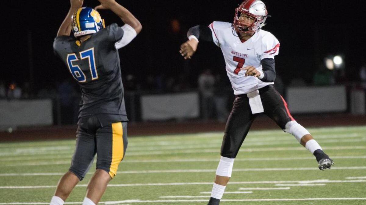Antelope Titans' Montel Aaron (7) throws a pass in the third quarter as Del Campo Cougars' Michael Scott (67) tries to block, as the Cougars host the Titans on Friday, October 23, 2015.