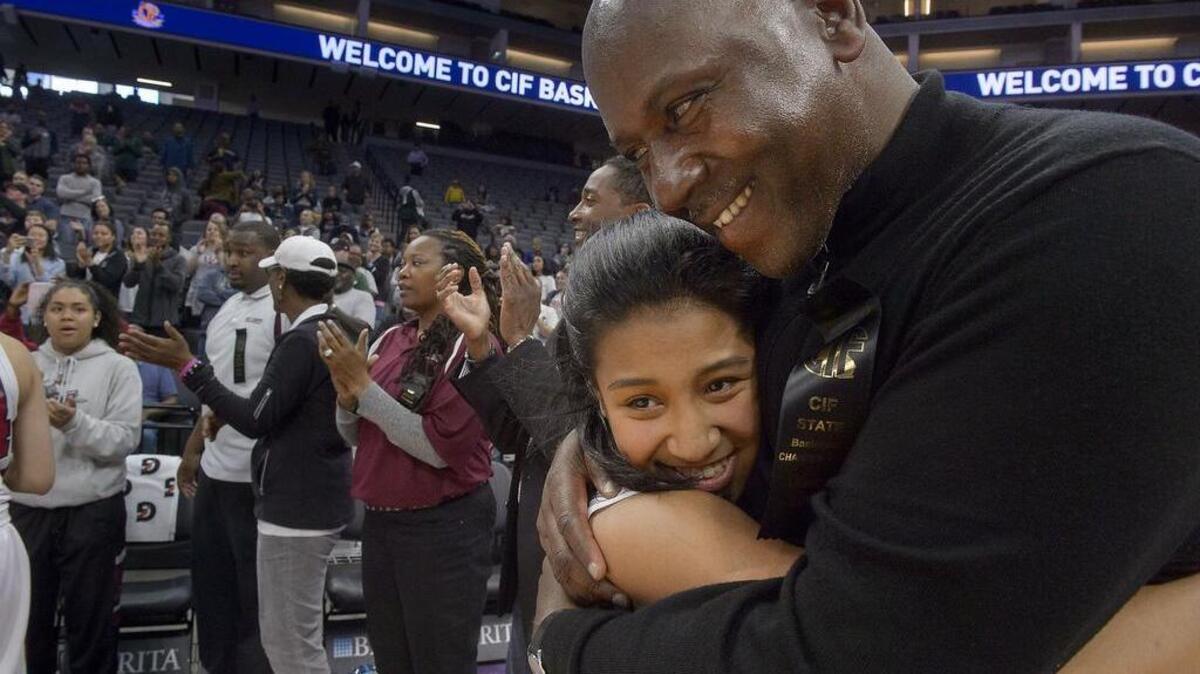 West Campus Warrior Gabriella Rones gets a hug from coach John Langston following the Division IV girls state basketball championship game Saturday with the Los Osos Grizzlies at Golden 1 Center. The Warriors won the title 63-55.