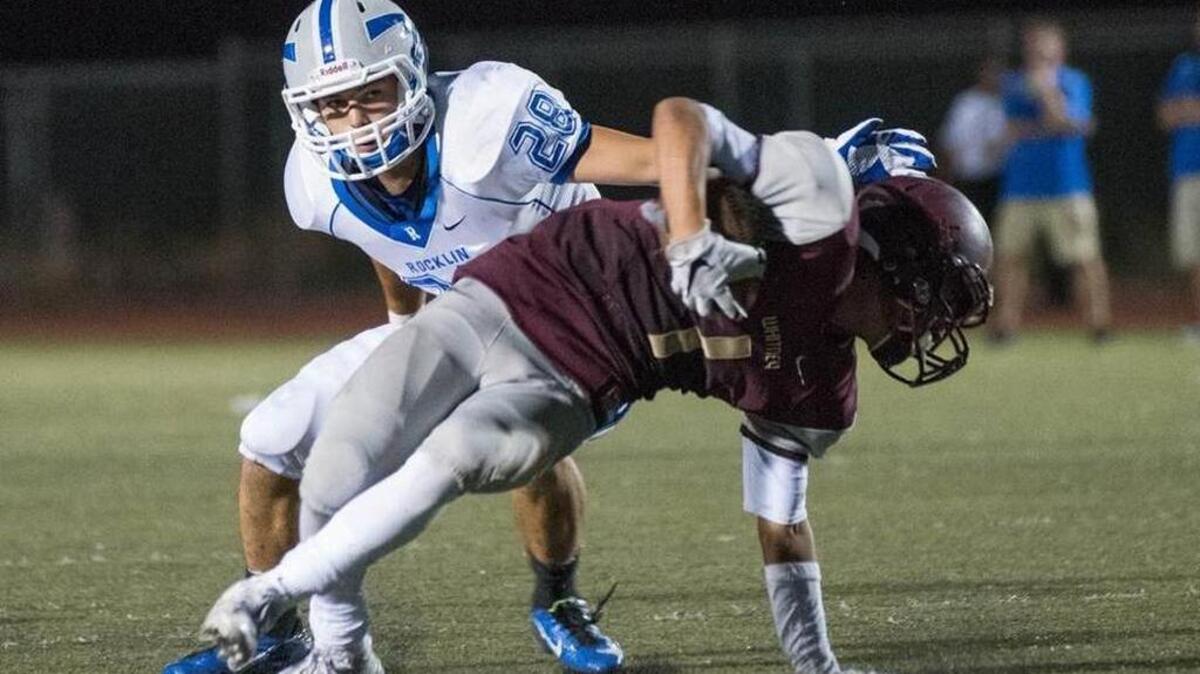 
Wildcats’ Brandon McCarter (1) receives a kickoff as the Thunder’s Nathaniel Harrison applies pressure.
