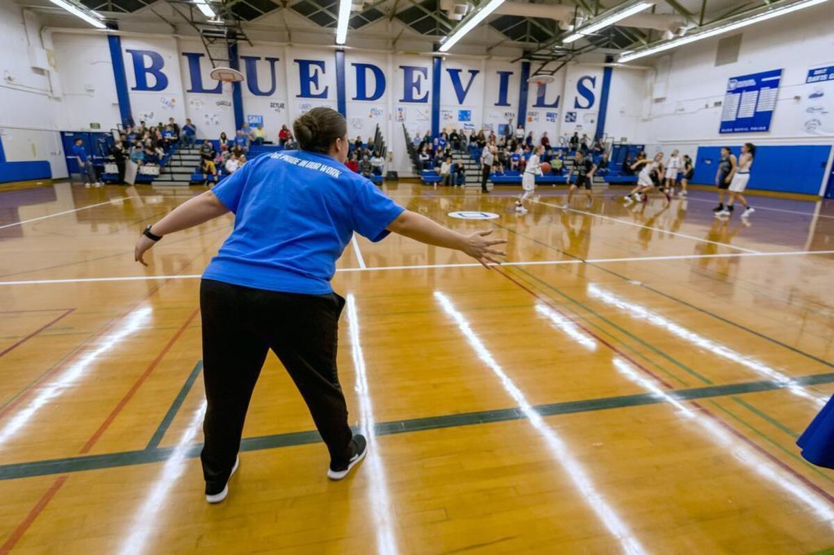 Davis High School Lady Blue Devils head coach Heather Highshoe directs at her team on the floor as they play the Sheldon Huskies on Wednesday.