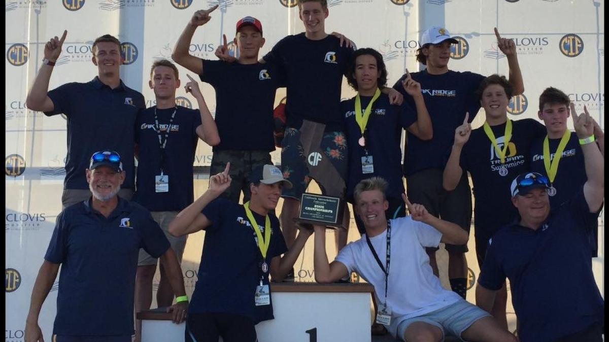 The Oak Ridge High School boys swimming team celebrates Saturday in Fresno after repeating as state champions.