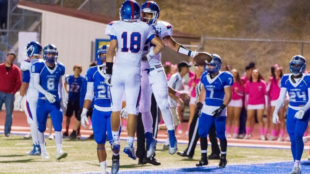 
Folsom’s Jake Jeffrey (18), celebrates with Tre Green (24), after Green's touchdown that gave the Bulldogs a 28-14 lead after the two point conversion against Rocklin last season.
