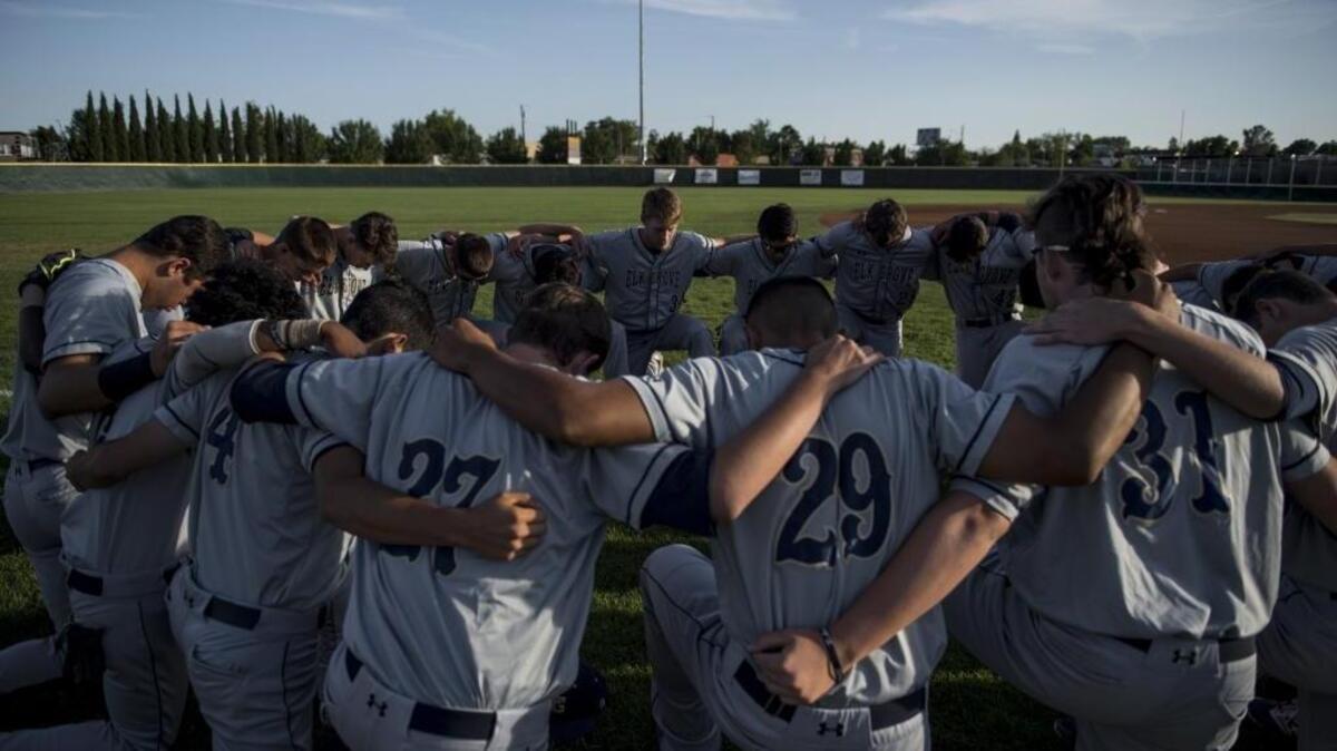 FILE - The Elk Grove Thundering Herd pray at the Sac Joaquin Section Division I North Baseball semifinals between the Elk Grove Thundering Herd and the Oak Ridge Trojans at Sac City College’s Union Stadium on Tuesday, May 24, 2016, in Sacramento, Calif. Elk Grove went on to win the division championship that year and the year before, and are looking for a three-peat to cap this season.