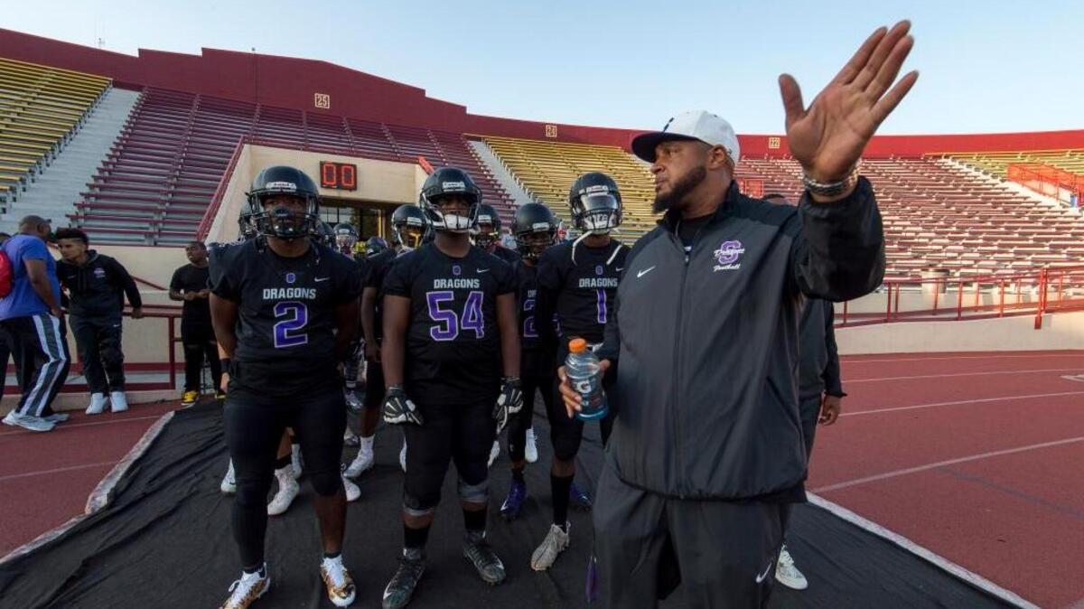 Sacramento Dragons coach Joe McCray talks to his team before hosting the Folsom Bulldogs at Hughes Stadium on Sept. 15.