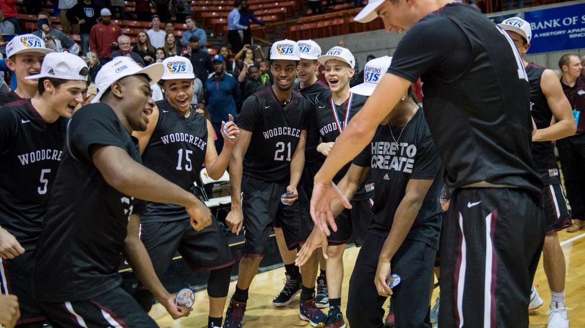 Woodcreek center Jordan Brown (21) and teammates celebrate after winning the Division I Sac-Joaquin Section title over Sheldon on Saturday in Stockton.